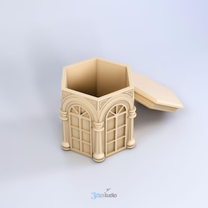 May include: A hexagonal wooden box with a hinged lid. The box is decorated with an ornate design of arches and columns, resembling a miniature building. The lid is open, revealing the empty interior of the box.