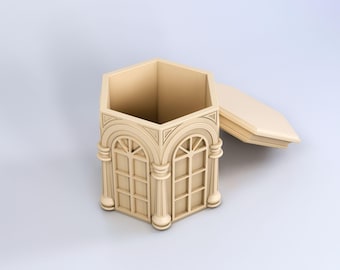 May include: A hexagonal wooden box with a hinged lid. The box is decorated with an ornate design of arches and columns, resembling a miniature building. The lid is open, revealing the empty interior of the box.
