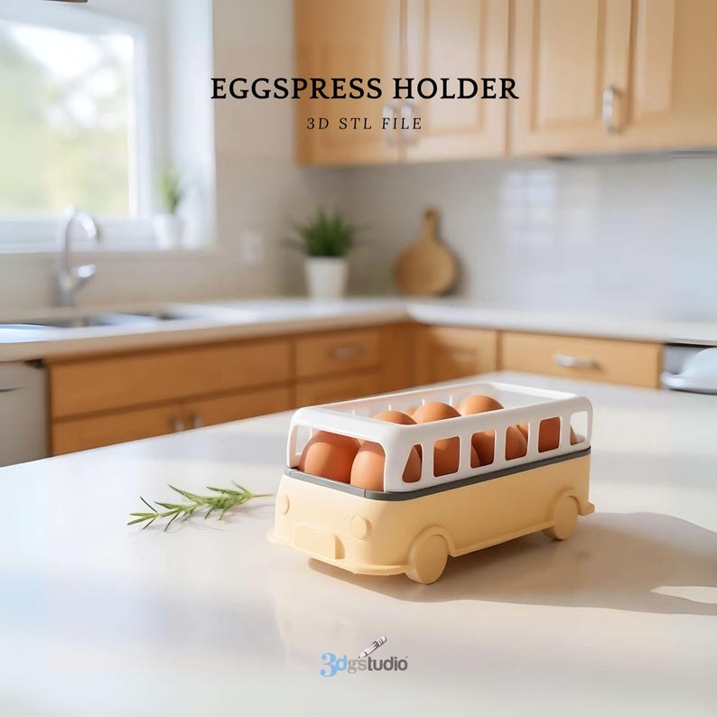May include: A yellow and white bus-shaped egg holder filled with brown eggs. The egg holder is on a white countertop with the text "EGGSPRESS HOLDER" and "3D STL FILE" in the background. A sprig of rosemary is on the counter.