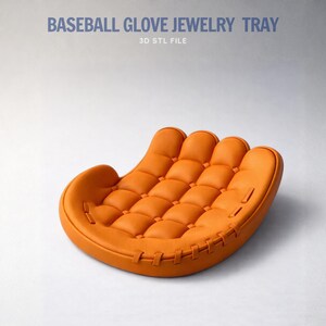Peut inclure: Un pr&eacute;sentoir &agrave; bijoux en forme de gant de baseball orange. Le pr&eacute;sentoir pr&eacute;sente un motif matelass&eacute; sur la paume et est cousu sur les bords. Le texte en haut indique "BASEBALL GLOVE JEWELRY TRAY" et "3D STL FILE".