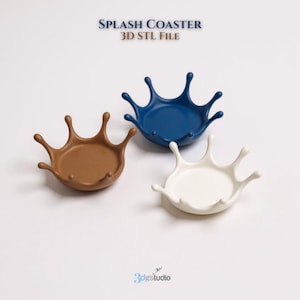 May include: Three splash-shaped coasters in brown, blue, and white. The coasters have a circular base with a splash design around the edge. The text "SPLASH COASTER 3D STL FILE" is at the top.