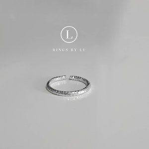 Könnte beinhalten: Ein silberner Hammerring mit strukturierter Oberfläche. Rings By Lu.