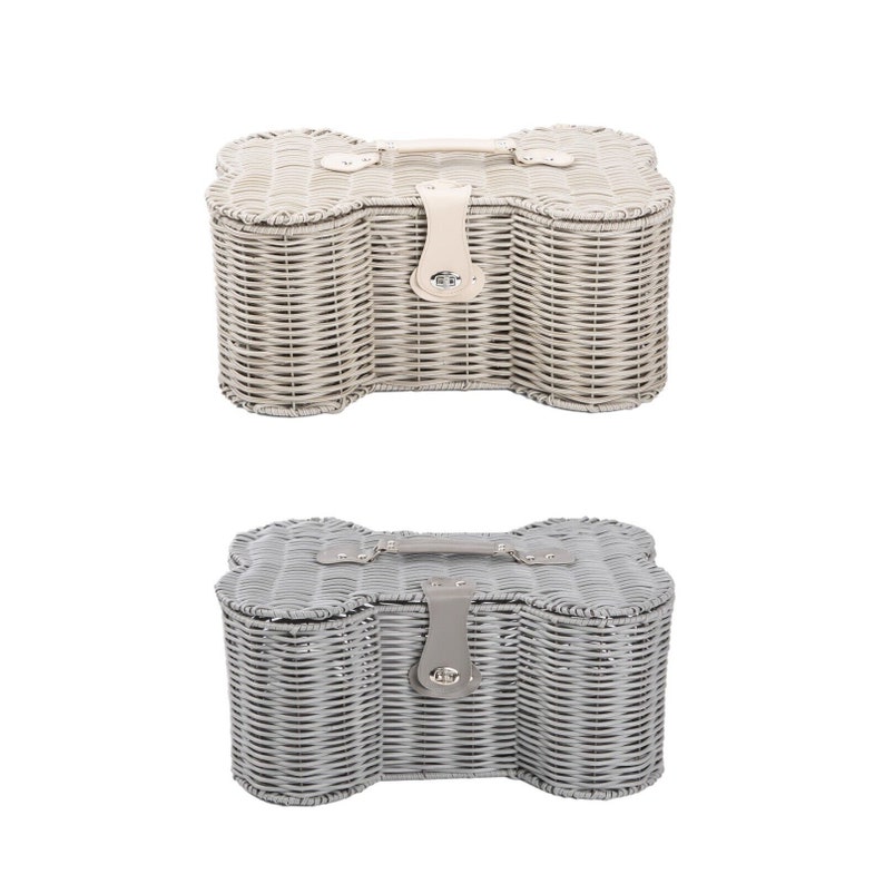 May include: Two bone-shaped storage baskets made of woven material. The top basket is light beige with a matching handle and a central latch. The bottom basket is grey with a matching handle and a central latch. Both feature a lid and woven sides.