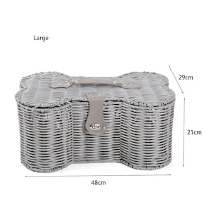 May include: A large grey woven basket shaped like a dog bone with a grey handle and a metal turn-lock closure. The basket features dimensions of 48cm in width, 29cm in depth, and 21cm in height as indicated by the text and arrows in the image.