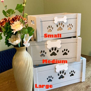 May include: Three wooden storage boxes with paw print cutouts and bone handles. The boxes are stacked from smallest to largest and labeled "Small", "Medium", and "Large".
