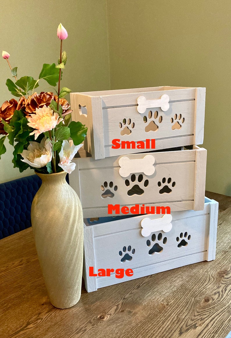 May include: Three wooden storage boxes with paw print cutouts and bone handles. The boxes are stacked from smallest to largest and labeled "Small", "Medium", and "Large".