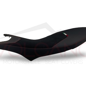 May include: Black motorcycle seat cover with red stitching and an Italian flag design.