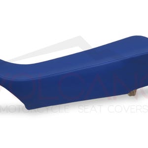 May include: A blue motorcycle seat cover. The cover is made of a durable, weather-resistant material and is designed to fit most standard motorcycle seats.