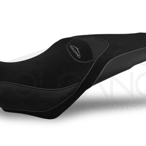May include: Black motorcycle seat cover with a gray "VOLCANO" logo. The seat cover has a textured surface and a white stitching detail.