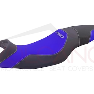 May include: A blue and black motorcycle seat cover with the text "F900" embroidered on it.