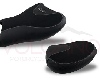 May include: Two black motorcycle seats with a textured surface and white stitching. The seats have the word "VOLCANO" printed on them. The seats are designed for motorcycles.