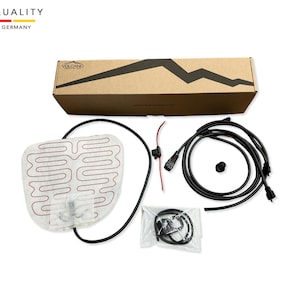 May include: A white heated seat cushion with red wiring, a black box, and black wiring. The cushion is packaged in a brown box with the text "VOLCANO" printed on it. The box also has the text "HIGH QUALITY MADE IN GERMANY" printed on it.
