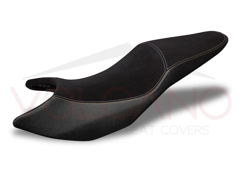 May include: Black motorcycle seat cover with yellow stitching. The seat cover is made of a soft, durable material and is designed to provide a comfortable ride.