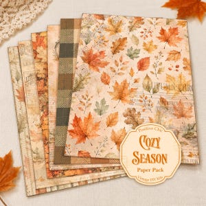 May include: A set of rectangular decorative paper sheets featuring autumn-themed patterns including orange and brown maple leaves, plaid designs, and vintage newspaper text. A beige octagonal label in the corner reads Positive Chic COZY SEASON Paper Pack.