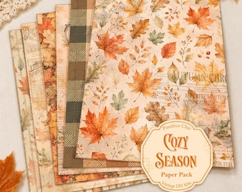 May include: A set of rectangular decorative paper sheets featuring autumn-themed patterns including orange and brown maple leaves, plaid designs, and vintage newspaper text. A beige octagonal label in the corner reads Positive Chic COZY SEASON Paper Pack.