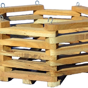 May include: A hexagonal wooden hanging planter with metal hooks. The planter is made of natural wood and has a rustic look.