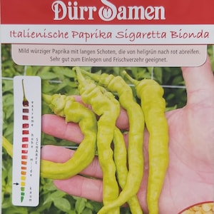 May include: A packet of Italian pepper seeds called "Sigaretta Bionda". The packet shows a hand holding several long, thin, yellow peppers. The text on the packet says "Mild spicy pepper with long pods that ripen from light green to red. Very good for pickling and fresh consumption."