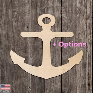 May include: A wooden anchor cutout with a natural wood finish. The anchor has a classic design with a ring at the top, a horizontal bar, and curved arms. The text "+ Options" is in pink. The words "MADE IN USA" are in the bottom left corner.