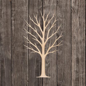 May include: A light-colored wooden tree cutout with a trunk and numerous branches. The tree is set against a backdrop of vertical, weathered wooden planks. The tree's design is simple and natural.
