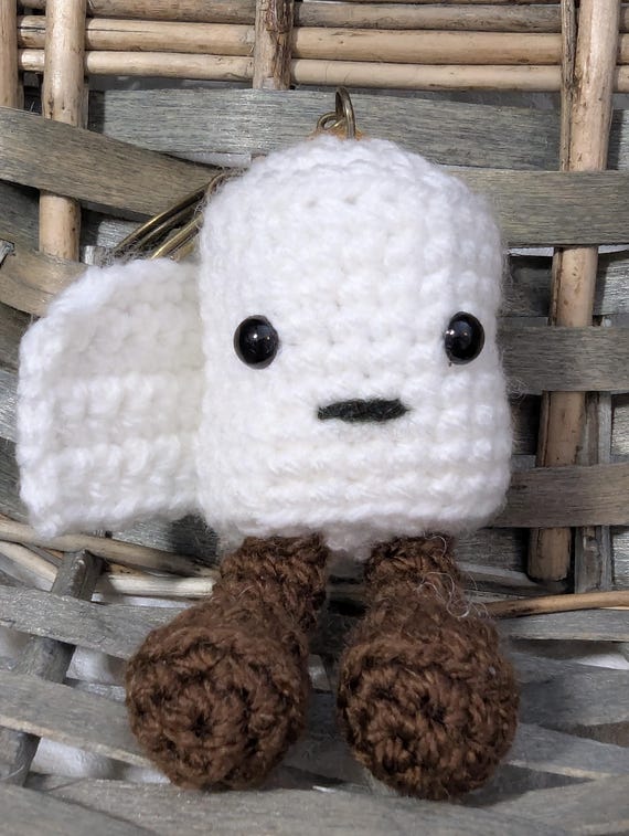 A teeny-tiny crocheted toilet roll keyring — absurdly specific, genuinely handmade amigurumi humor that punches way above its $12 price tag.