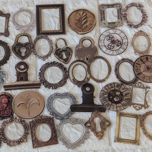 May include: A selection of vintage paper cutouts, featuring ornate frames, lockets, and clock faces. The colour scheme is predominantly brown, with gold and silver highlights. The designs showcase intricate details and textures, ideal for scrapbooking or craft projects.