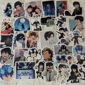 May include: A selection of anime character stickers in various poses and colours. Many stickers feature characters with black hair and blue flames. Some stickers include Japanese text. The stickers are on a white background.