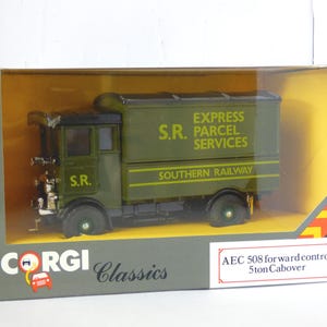 May include: A green and black Corgi Classics AEC 508 forward control 5-ton Cabover model truck. The truck has the text "EXPRESS S.R. PARCEL SERVICES SOUTHERN RAILWAY" printed on the side. The model is in its original packaging.