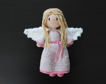 May include: A crocheted angel doll with white wings, a pink dress, and long blonde hair.