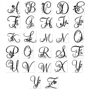 May include: A set of 26 black and white alphabet letter stamps with floral designs. Each letter is in a cursive font with a vine and flower design.