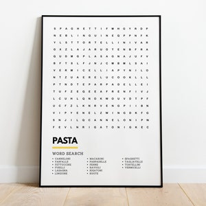 May include: A black framed poster with a white background and black text. The text is a word search puzzle with the word "PASTA" at the top. The word search includes various types of pasta, such as spaghetti, lasagna, and ravioli. Below the word search is a list of the pasta types included in the puzzle.