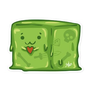 May include: A green, cartoon-style sticker featuring a smiling, cube-shaped slime monster with a red heart tongue. The slime has a skull, diamond, sword, and bone illustrations. The artist's signature and year are in the bottom right corner.