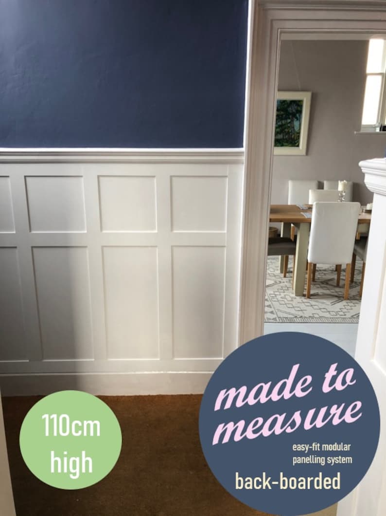 May include: White paneled wall with a dark blue top and a light brown carpet. The wall is 110cm high and the text "made to measure easy-fit modular panelling system back-boarded" is on a blue circle.