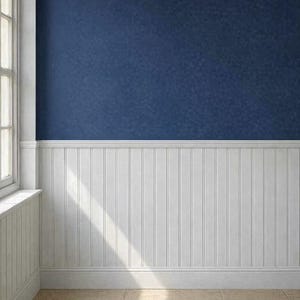 May include: Interior shot of a room with a navy blue textured wall above white wainscoting. A window with white trim is visible on the left. The floor is tiled in a light beige color. Sunlight streams across the floor.