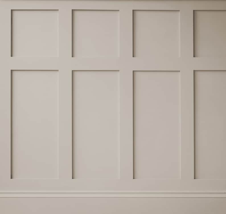 May include: A white wall with a raised panel design. The panels are arranged in a grid pattern, creating a classic and elegant look.