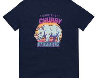 May include: Navy blue t-shirt featuring a cartoon rhino with the text "Save the Chubby Unicorns." The rhino is light blue with a yellow horn, set against a sunset design. The text is in pink and purple.