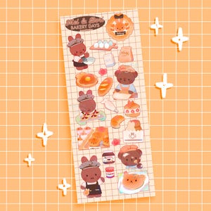 Puede incluir: Una hoja de pegatinas con un patrón de cuadrícula e ilustraciones de productos horneados y personajes de dibujos animados. El texto "Mel & Bon Bakery Days" está en la parte superior. Las ilustraciones incluyen huevos, pan y osos.