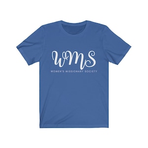 May include: A royal blue t-shirt featuring the white cursive text "WMS" above the words "WOMEN'S MISSIONARY SOCIETY" in a smaller, sans-serif font. The shirt has short sleeves and a crew neck.