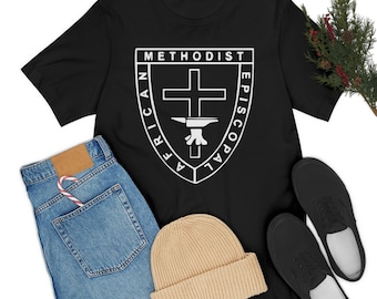 May include: Black t-shirt with a white graphic of the African Methodist Episcopal Church logo. The logo features a cross, an anvil, and the words "African Methodist Episcopal".