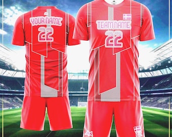 May include: Red soccer uniform set with white and gray geometric design. The jersey features the text "TEAM NAME" and the number "22". The shorts also have the number "22". The back of the jersey has the text "YOUR NAME" and the number "22".