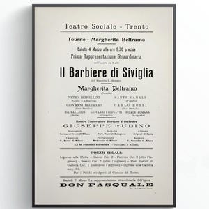 May include: A framed vintage poster in black and white, advertising a performance of "Il Barbiere di Siviglia" at the Teatro Sociale in Trento. The poster includes the names of the performers and director, Margherita Beltramo.