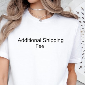 May include: White t-shirt with the text "Additional Shipping Fee" printed on the front.
