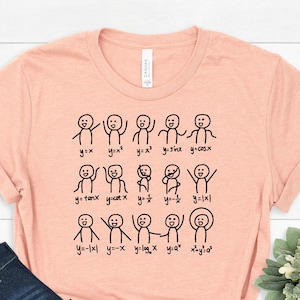 May include: A peach-coloured t-shirt with a graphic of stick figures representing different mathematical equations. The equations include y=x, y=x², y=x³, y=sinx, y=cosx, y=tanx, y=cotx, y=1/x, y=-1x1, y=-x, y=logx, y=a^x, x^y=a^2.