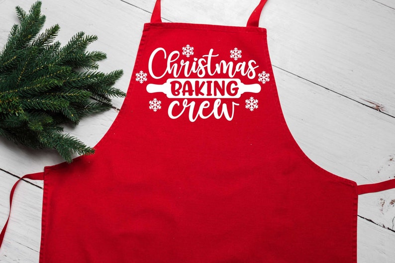 May include: Red Christmas baking apron with white text that says "Christmas Baking Crew" and a rolling pin graphic.