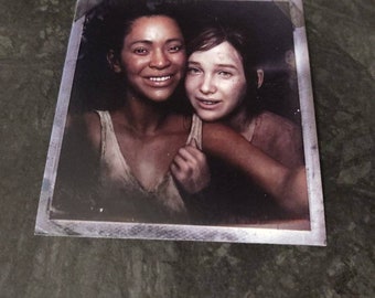 The Last of Us Part 1 Left behind Riley and Ellie Polaroid photo (soiled frame version)