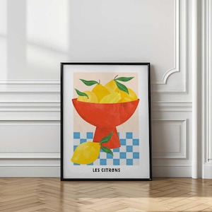 May include: A framed art print featuring a still life of lemons. The image shows a vibrant red bowl filled with yellow lemons and green leaves, set against a checkered blue and white background. The text "LES CITRONS" is at the bottom.