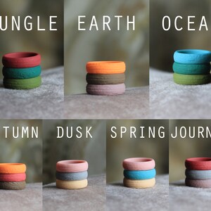 May include: Stackable silicone rings in various colors and patterns, including Jungle, Earth, Ocean, Autumn, Dusk, Spring, Journey. The rings are made of a soft, comfortable material and are perfect for everyday wear.
