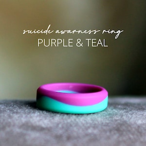 May include: Purple and teal silicone ring with the text "suicide awareness ring" in white lettering.