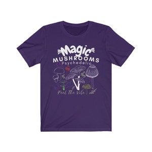 May include: Purple short-sleeved t-shirt with a white graphic of mushrooms and the text "Magic Mushrooms Psychedelic Feel The Vibe".