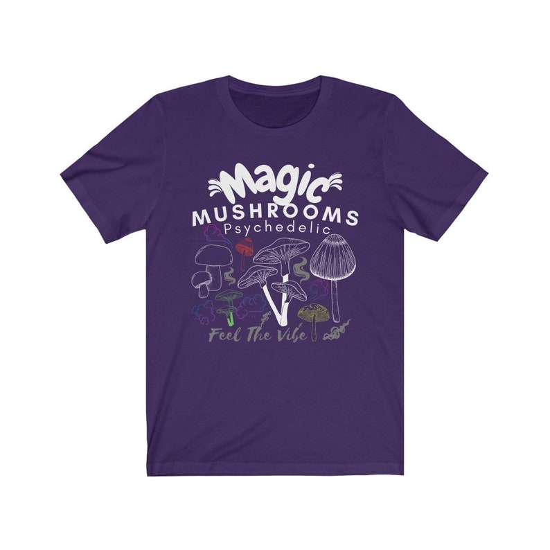 May include: Purple short-sleeved t-shirt with a white graphic of mushrooms and the text "Magic Mushrooms Psychedelic Feel The Vibe".