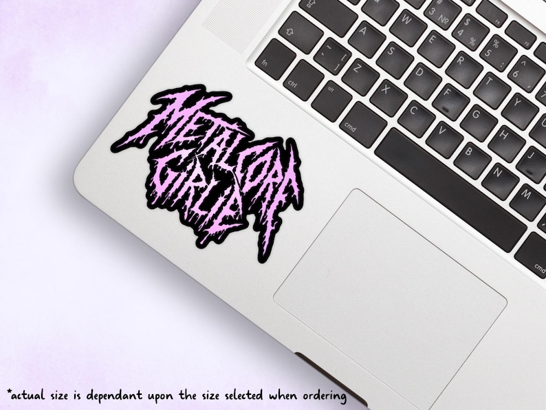 May include: A pink and black sticker with the text "Metalcore Girl" in a stylized font.